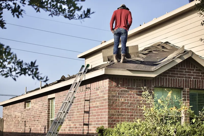 Professional roofer working on a residential roof in White Church Place